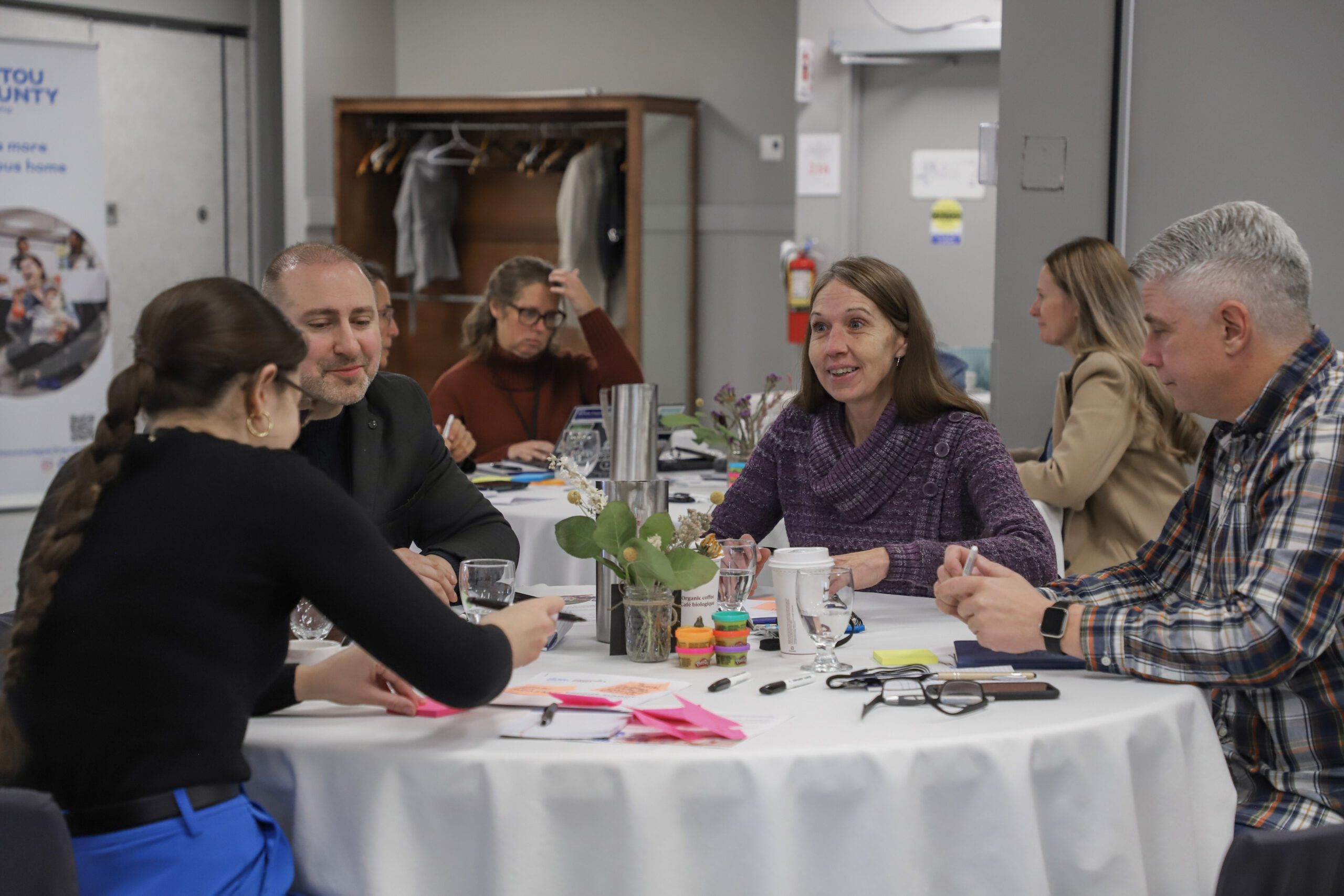 Image of people talking around a table.