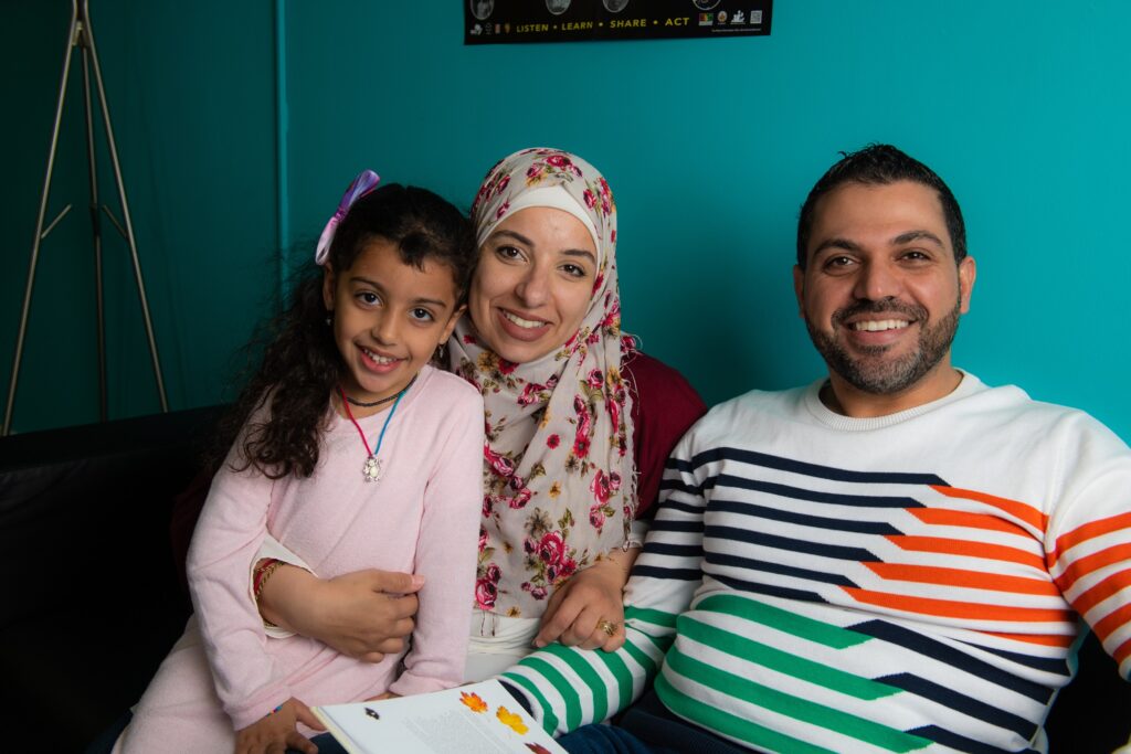 A family sitting together on a couch.